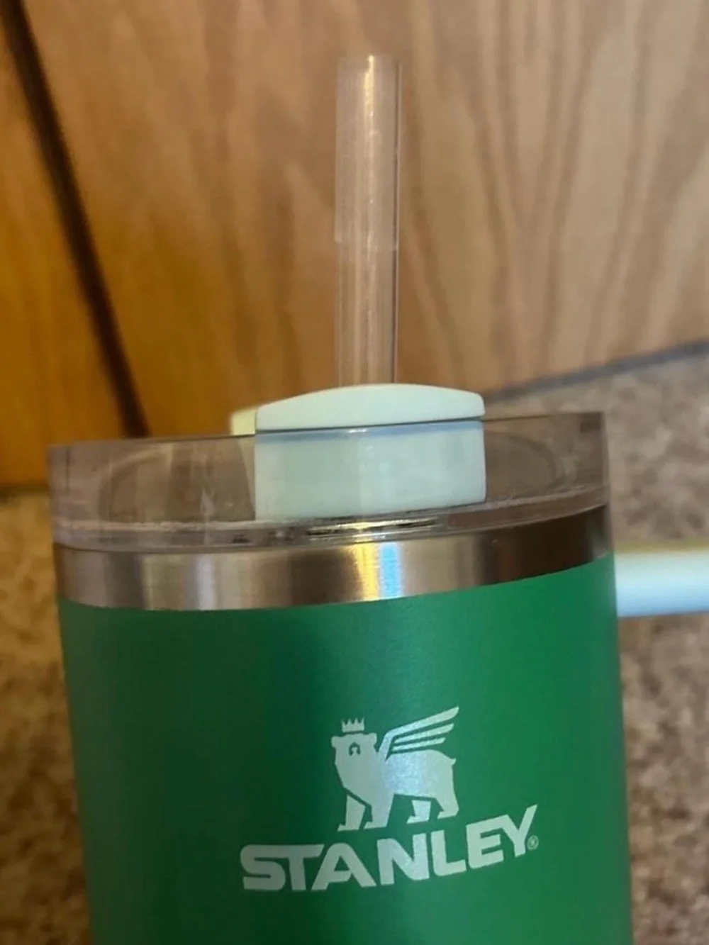 Stanley Green Tumbler with Light Blue Handle and Lid Accent